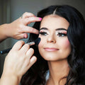 Makeup artist applying makeup to a model's face